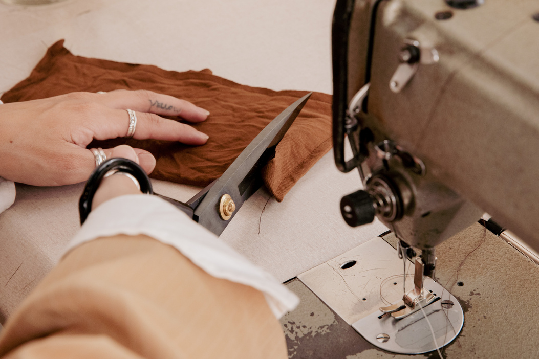 Fashion Designer Cutting a Fabric